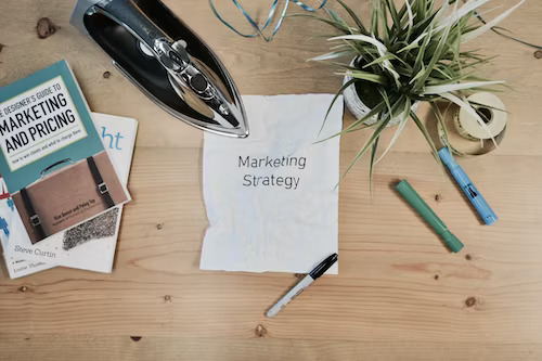 Small business marketing strategy outlined on a note on a wooden table.