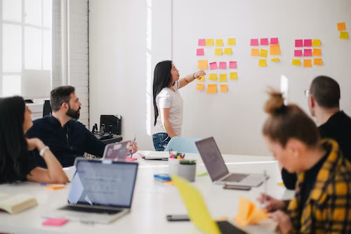 Small business marketing plan tips on sticky notes during a team meeting