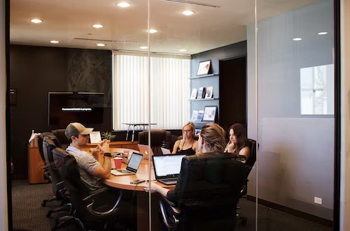 Digital marketing consultant in Jupiter strategizing with a team at their office table.