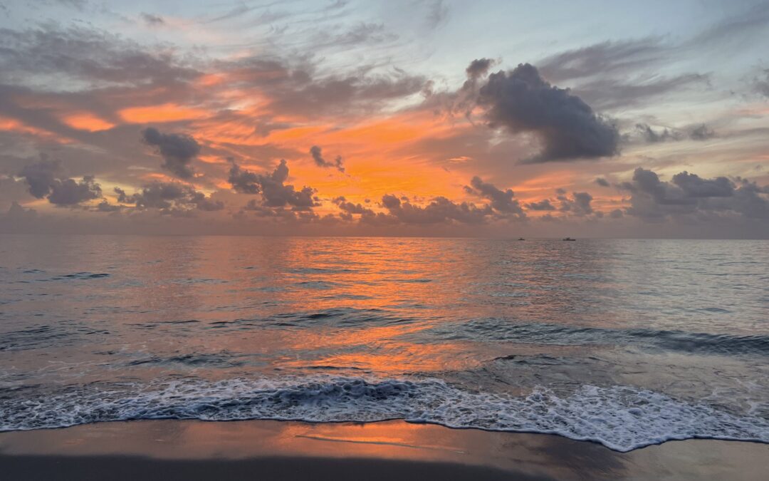 Hobe Sound website design agency captures ocean sunset with clouds and sand.