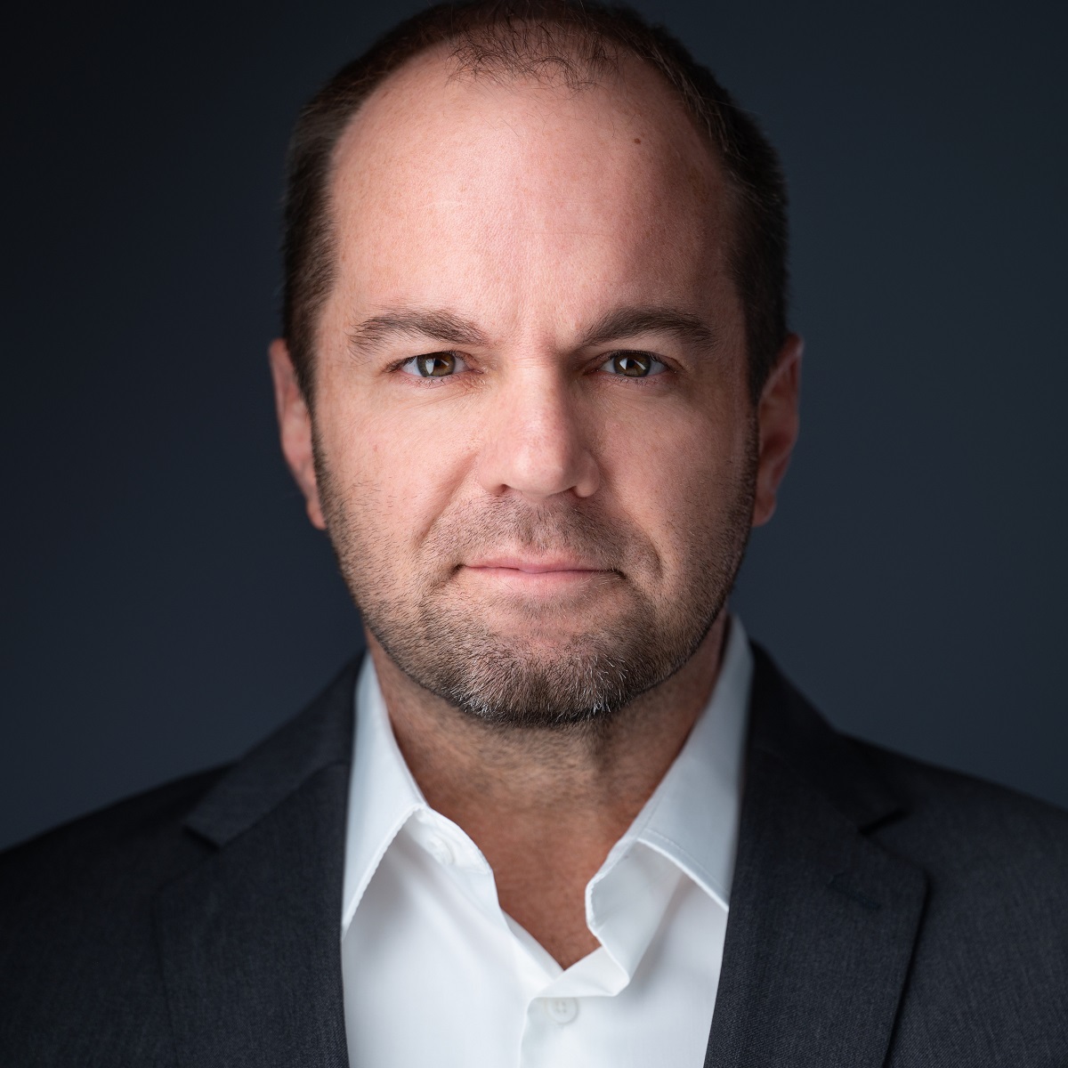 Entrepreneur and strategic advisor Nick Berry's headshot on a dark gray background.